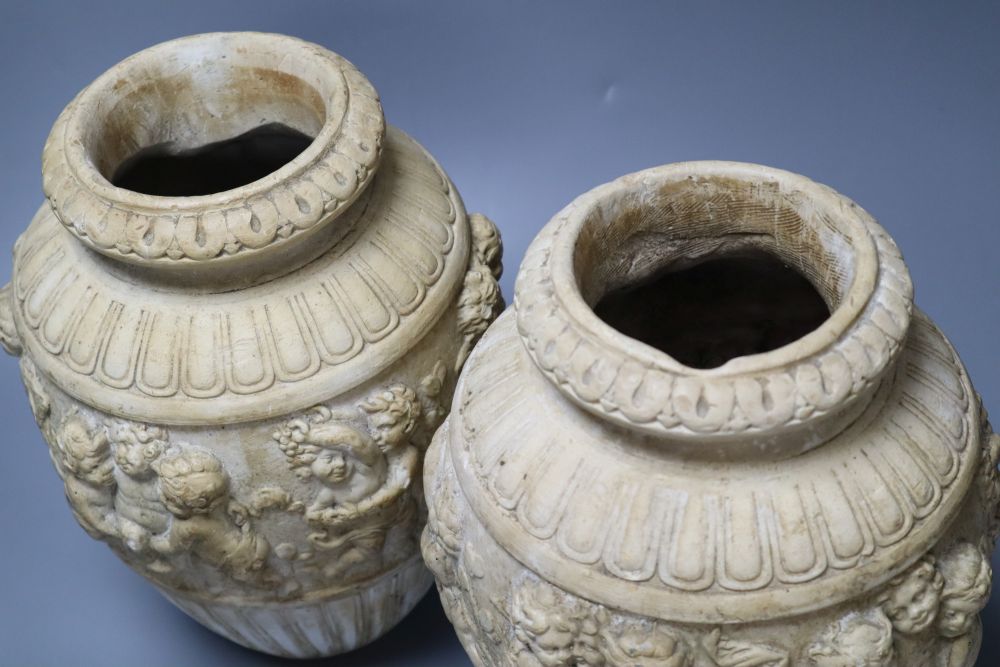 A pair of 19th century earthenware vases relief moulded in Italian Renaissance style, 30cm